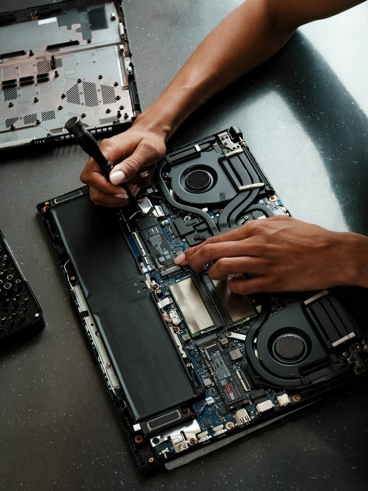 Technician repairing a laptop